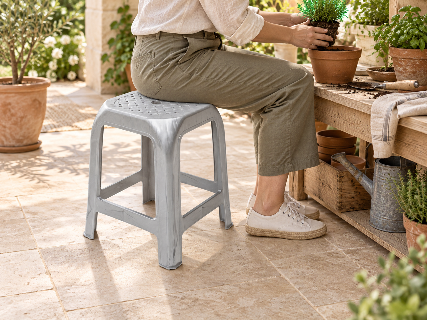 BURDEM Plastic Stool Clasico 3 used as tall practical seating in a covered garden workspace