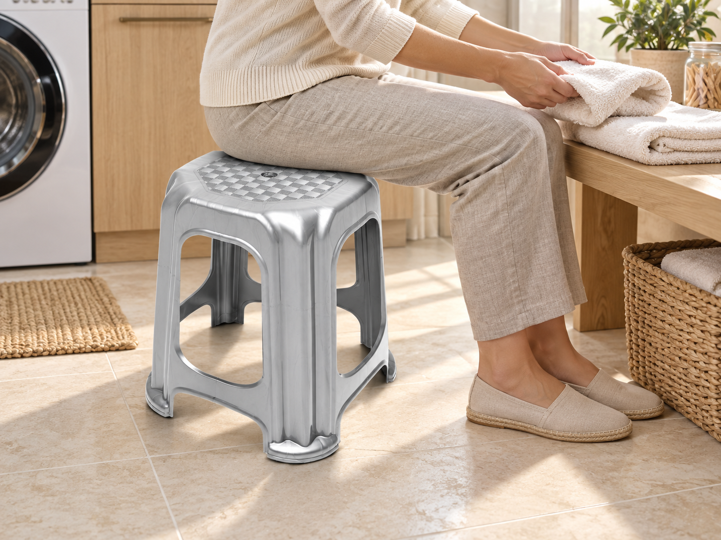 BURDEM Plastic Stool Lux 3 used as tall seating while folding laundry